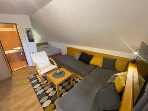 a living room with a couch and a chair at Apartmán Ivko in Letohrad