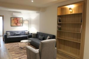 a living room with a couch and chairs and a book shelf at The Capri Hotel Osmanbey in Istanbul