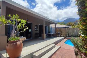 a house with a patio and a swimming pool at Scenic house with splash pool in Cape Town