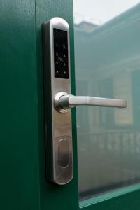 a door with a silver handle on a green door at Ozone Silver&Gold in Budapest
