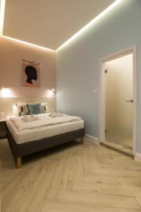 a bedroom with a bed and a door to a room at Ozone Silver&Gold in Budapest