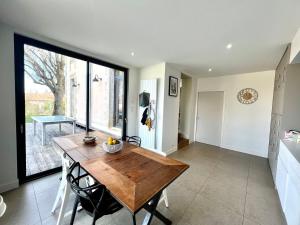 a kitchen and dining room with a wooden table at Beautiful family home in Poitiers