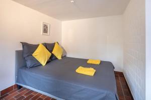 a bedroom with a blue bed with yellow pillows at Hamburg City Apartment in Hamburg