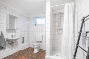 a white bathroom with a toilet and a sink at Hamburg City Apartment in Hamburg