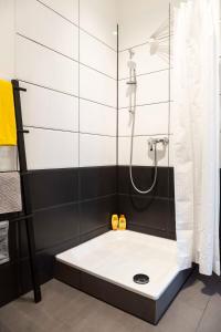 a bathroom with a shower with a sink at Spacious Family Apartment at Mauerpark plus SelfCheckIn in Berlin