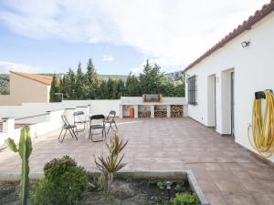 a patio with chairs and tables on a white building at Ca La Carmina in Pontons