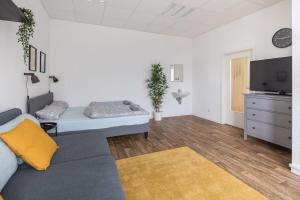 a living room with a bed and a tv at Spacious 2 BR Apartment Hamburg in Hamburg