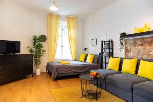 a living room with a couch and yellow pillows at Shabby Chic plus Self CheckIn and Free Street Parking in Berlin