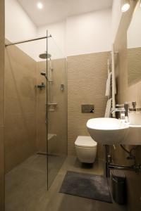 a bathroom with a sink and a toilet and a shower at Ozone Silver&Gold in Budapest