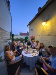 a group of people sitting around a table eating at Manoir des Roches 41 in Bourré