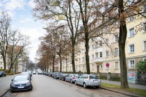 a row of cars parked on the side of a street at Big Central Apartment near Rotkreuzplatz with 3 BR for 12 PAX in Munich