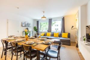 a dining room and living room with a table and chairs at 3 Bedroom apartment in great location in Hamburg