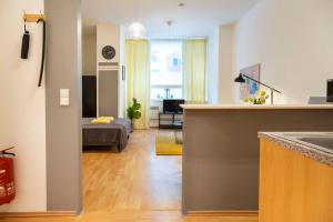 a kitchen and a living room with a couch at Cozy 2 room apartment next to Hermannstraße in Berlin