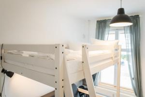 a white bunk bed in a room with a window at Shabby Chic plus Self CheckIn plus Free Street Parking in Berlin