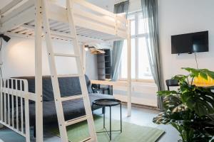 a bedroom with a loft bed with a desk and a bed at Shabby Chic plus Self CheckIn plus Free Street Parking in Berlin