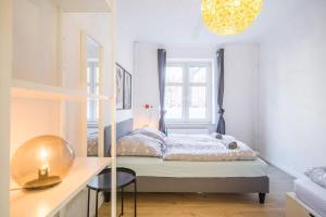 a bedroom with a bed and a table and a mirror at Spacious Two BR Close To Stadtpark and Street Parking in Hamburg