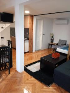 a living room with a couch and a table at Apartman 2 Uzice in Užice