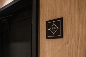 a door with a black and white sign on it at Shinzan Kinosaki in Toyooka