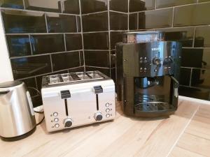 a toaster and a coffee maker on a counter at Family Apartment Moabit in Berlin