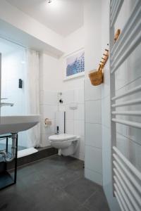 Baño blanco con aseo y lavamanos en Hamburg City Apartment for 7 en Hamburgo