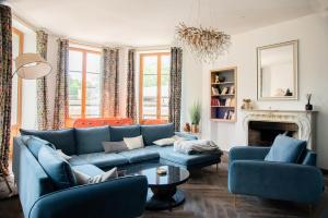 a living room with a blue couch and chairs at Villa Bagatelle in Aix-les-Bains