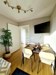 a living room with a dining room table and chairs at Urban Living - Top Floor Apartment in Hamburg