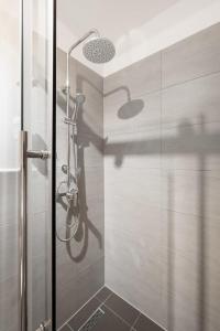 a bathroom with a shower with a glass door at Apartment close to Theresienwiese in Munich +10 photos