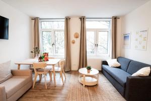 a living room with a couch and a table at Hamburg - Cosy Apartment for 5 in Hamburg