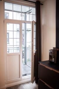 an open door to a balcony in a room at Hamburg - Cosy Apartment for 4 in Hamburg