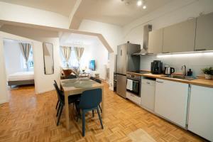 a kitchen with a table and chairs in a room at Living in Hamburg City Center in Hamburg