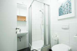 a bathroom with a shower and a toilet and a sink at Hamburg City Center Apartment in Hamburg