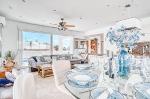 a living room with a glass table and chairs at Marina Luah in Benissa