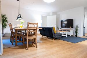 sala de estar con mesa, sillas y TV en Four Bedroom in urban location, en Hamburgo