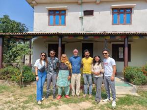 a group of people standing in front of a house at Bardiya Eco Safari Homestay in Bhurkīā