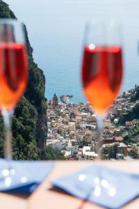 two glasses of wine sitting on a table with a view at Donna Luisa Suites 19 Amalfi view - free parking in Pontone
