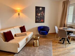 a living room with a couch and a table at Posthotel Arnold in Gunzenhausen