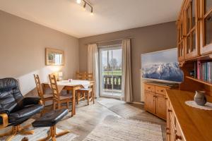 a dining room with a table and chairs and a window at Ferienwohnung Bergpanorama in Oberaudorf