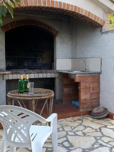 an outdoor patio with a table and a sink at Apartments Jaca in Rab