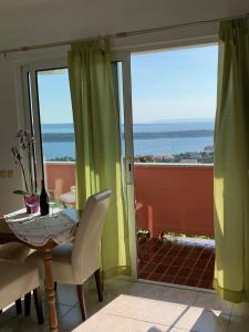 a dining room with a table and a view of the ocean at Apartments Jaca in Rab