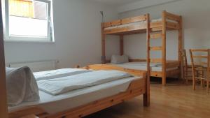 two bunk beds in a room with a window at Gästehaus Sibylle in Rust