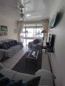 a living room with couches and a coffee table at Libra Holiday Flats 1 in Margate