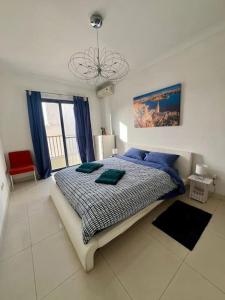Un dormitorio con una cama con almohadas azules. en 2 Bedroom Apartment - 5 mins from the sea en St. Paul's Bay
