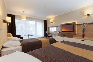 Кровать или кровати в номере Hotel Wellness Medical Spa Unitral