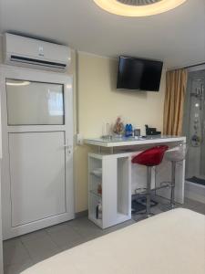 a kitchen with a counter and a bar with a stool at Small apartments in Lamone in Lamone