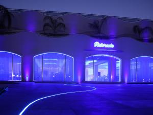 a room with purple lights and a building at Villaggio Jonio Blu in Bianco