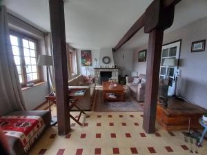 a living room with a couch and a table at Le Puy Maury in Augne