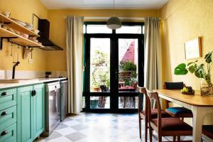 a kitchen with a table and a door to a patio at Ayvalık merkezde bahçe kullanımlı daire in Ayvalık