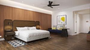 a bedroom with a bed and a ceiling fan at Lone Pine, Penang, a Tribute Portfolio Resort in Batu Ferringhi