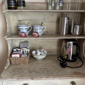 a shelf with pots and pans and baskets on it at Tigh an Eilean Hotel in Shieldaig