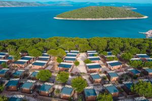 an aerial view of a group of houses with the ocean in the background at Obonjan Island Resort in Šibenik